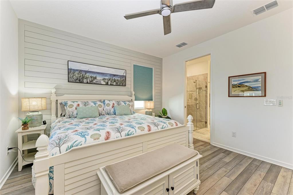 9272 Ballaster Pointe Loop Parrish, FL 34221 - Photo 24 of 79 a bedroom with a large bed and a chandelier