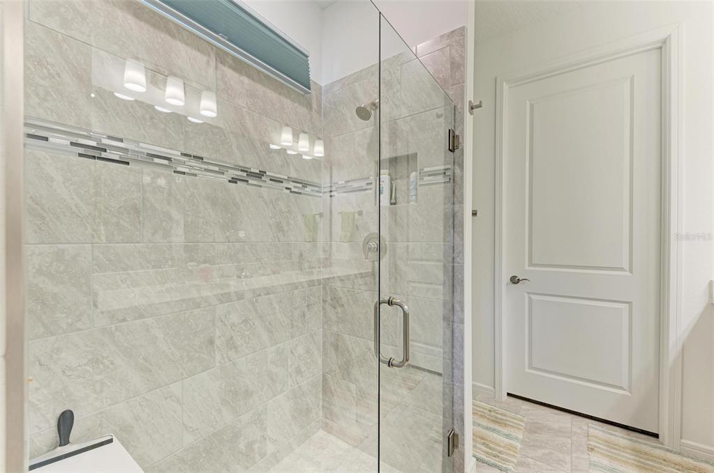 9272 Ballaster Pointe Loop Parrish, FL 34221 - Photo 26 of 79 a bathroom with a glass shower door