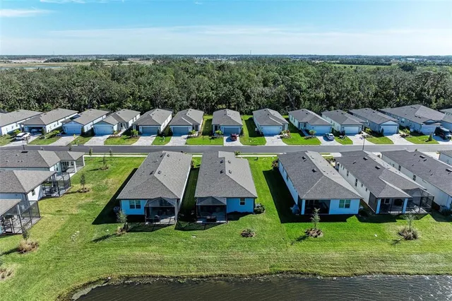 a dining room with wooden floor and furniture