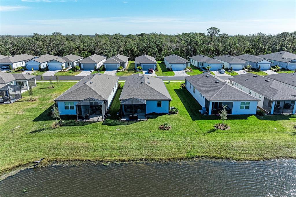 9272 Ballaster Pointe Loop Parrish, FL 34221 - Photo 40 of 79 an aerial view of residential houses with outdoor space and trees