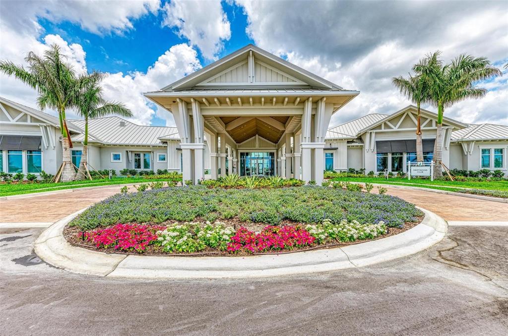 9272 Ballaster Pointe Loop Parrish, FL 34221 - Photo 50 of 79 a view of a white house with a large window and flower plants