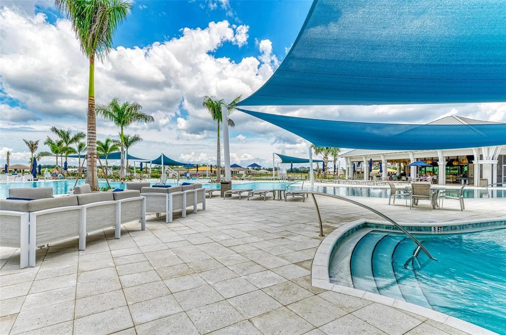 9272 Ballaster Pointe Loop Parrish, FL 34221 - Photo 53 of 79 a view of a swimming pool with outdoor seating