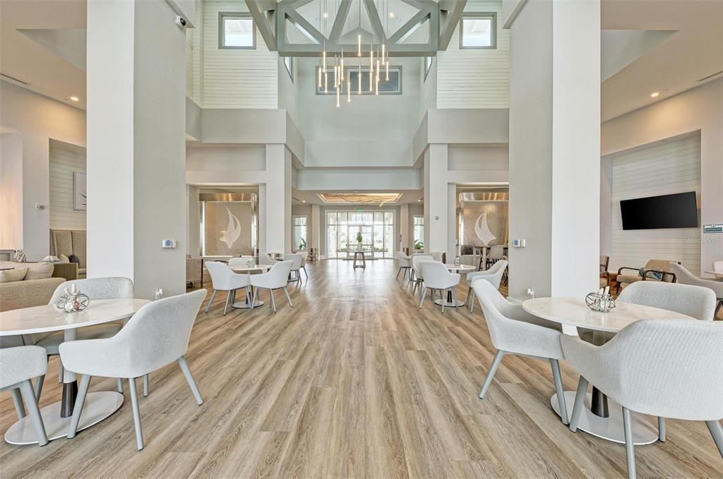 9272 Ballaster Pointe Loop Parrish, FL 34221 - Photo 59 of 79 a view of a dining room with furniture a chandelier and wooden floor