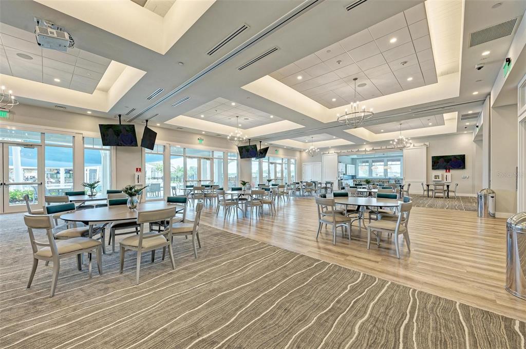 9272 Ballaster Pointe Loop Parrish, FL 34221 - Photo 62 of 79 a view of a dining hall with lots of furniture and wooden floor