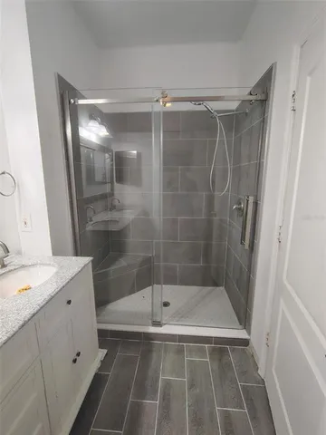 a bathroom with a shower and a sink