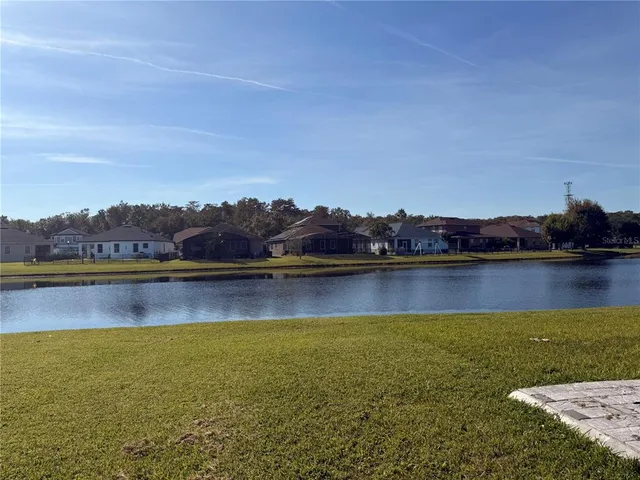 a view of an ocean with trees in the background