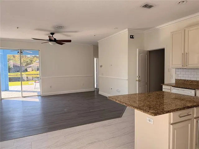 a kitchen with granite countertop a sink and a stove