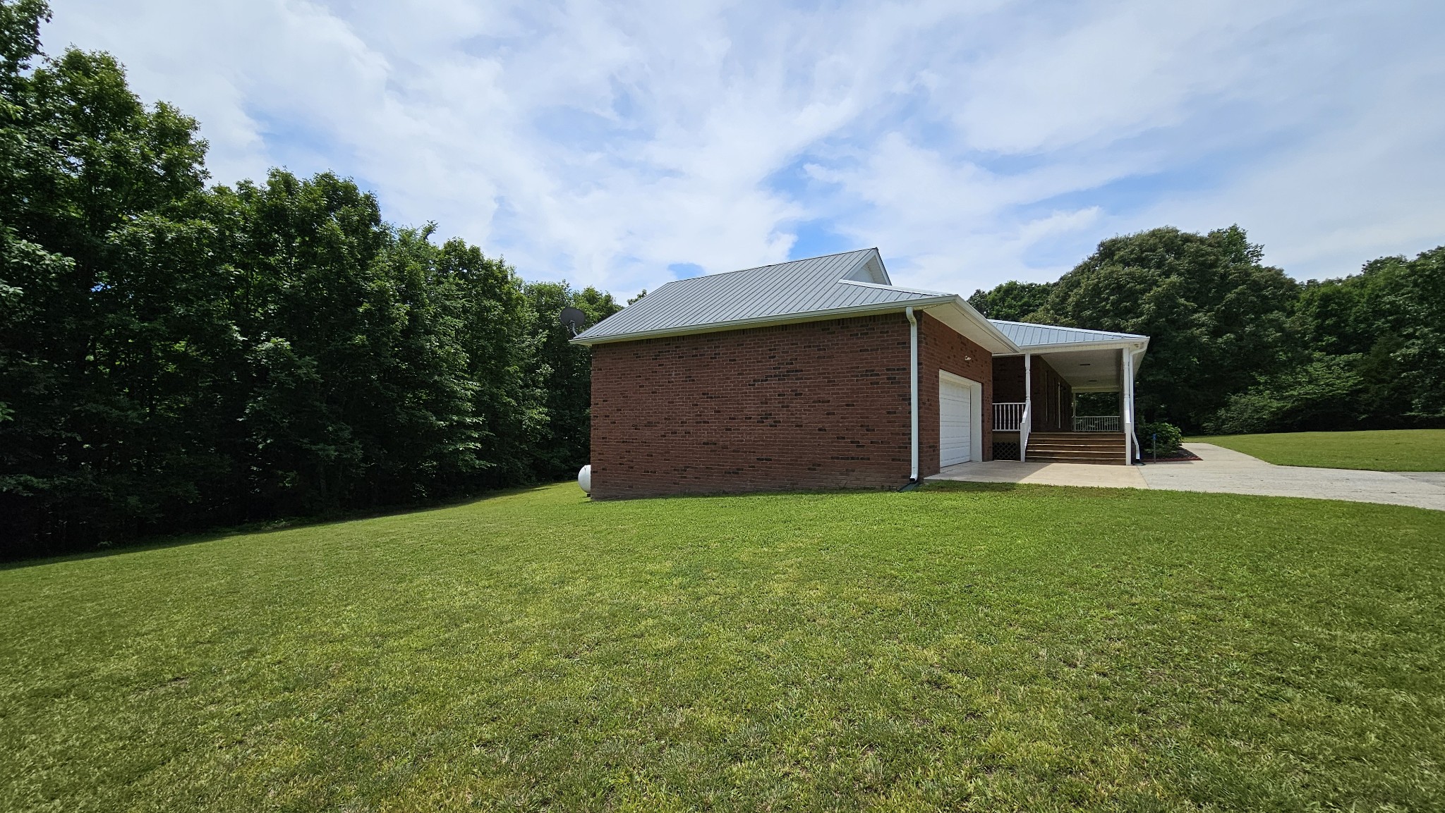 10985 Missionary Ridge Road Bon Aqua, TN 37025 - Photo 14 of 43 a backyard of a house with lots of green space and garden