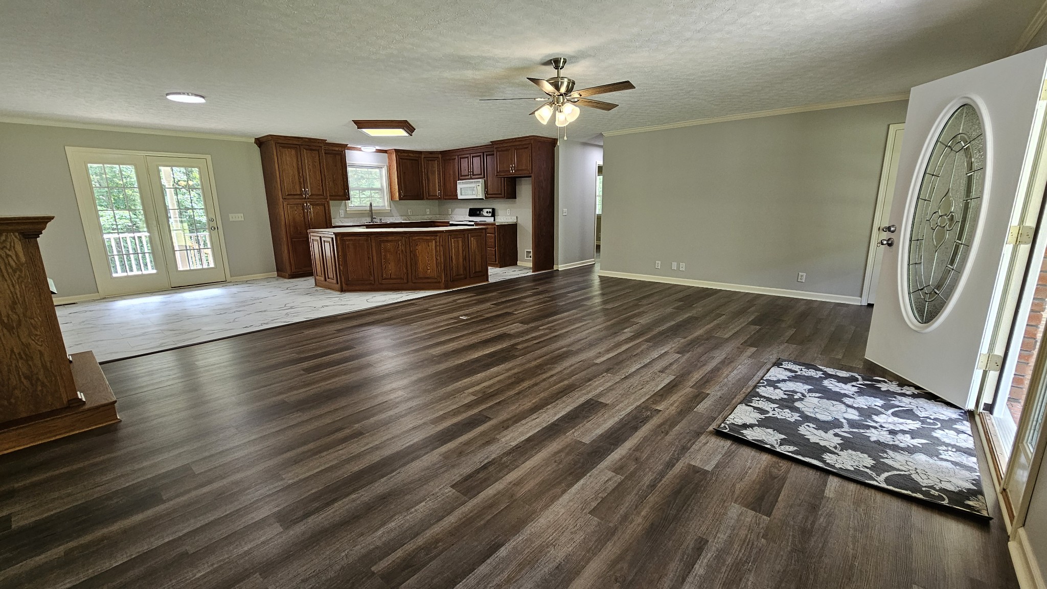 10985 Missionary Ridge Road Bon Aqua, TN 37025 - Photo 23 of 43 an empty room with wooden floor a ceiling fan and windows