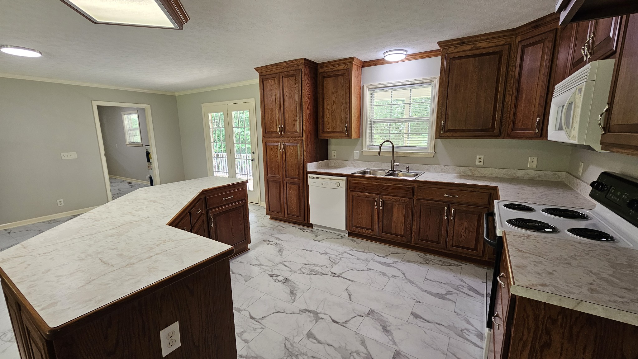 10985 Missionary Ridge Road Bon Aqua, TN 37025 - Photo 26 of 43 a kitchen with a stove a sink a refrigerator and wooden floor
