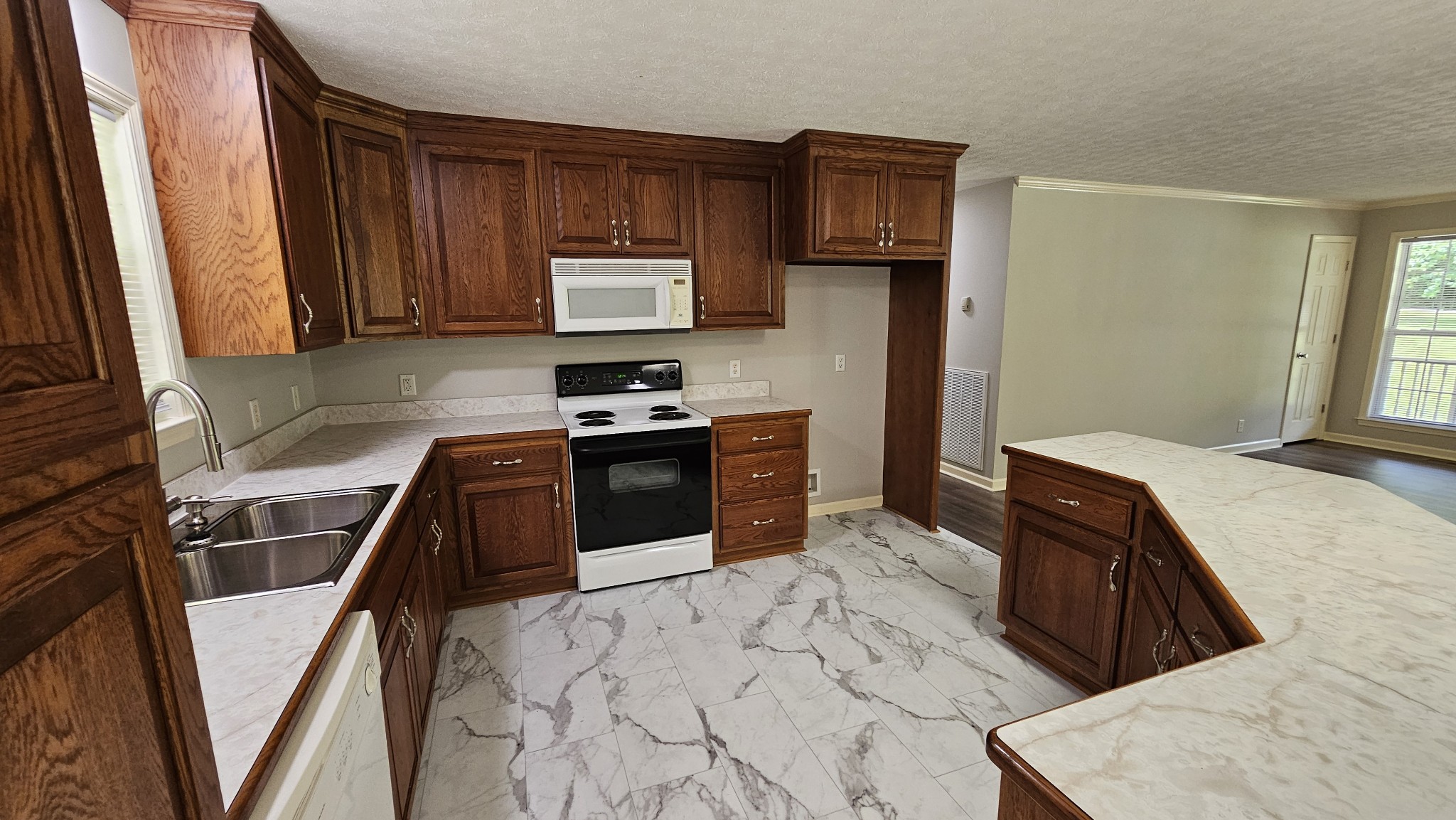 10985 Missionary Ridge Road Bon Aqua, TN 37025 - Photo 30 of 43 a kitchen with stainless steel appliances granite countertop wooden cabinets a stove a sink and a refrigerator