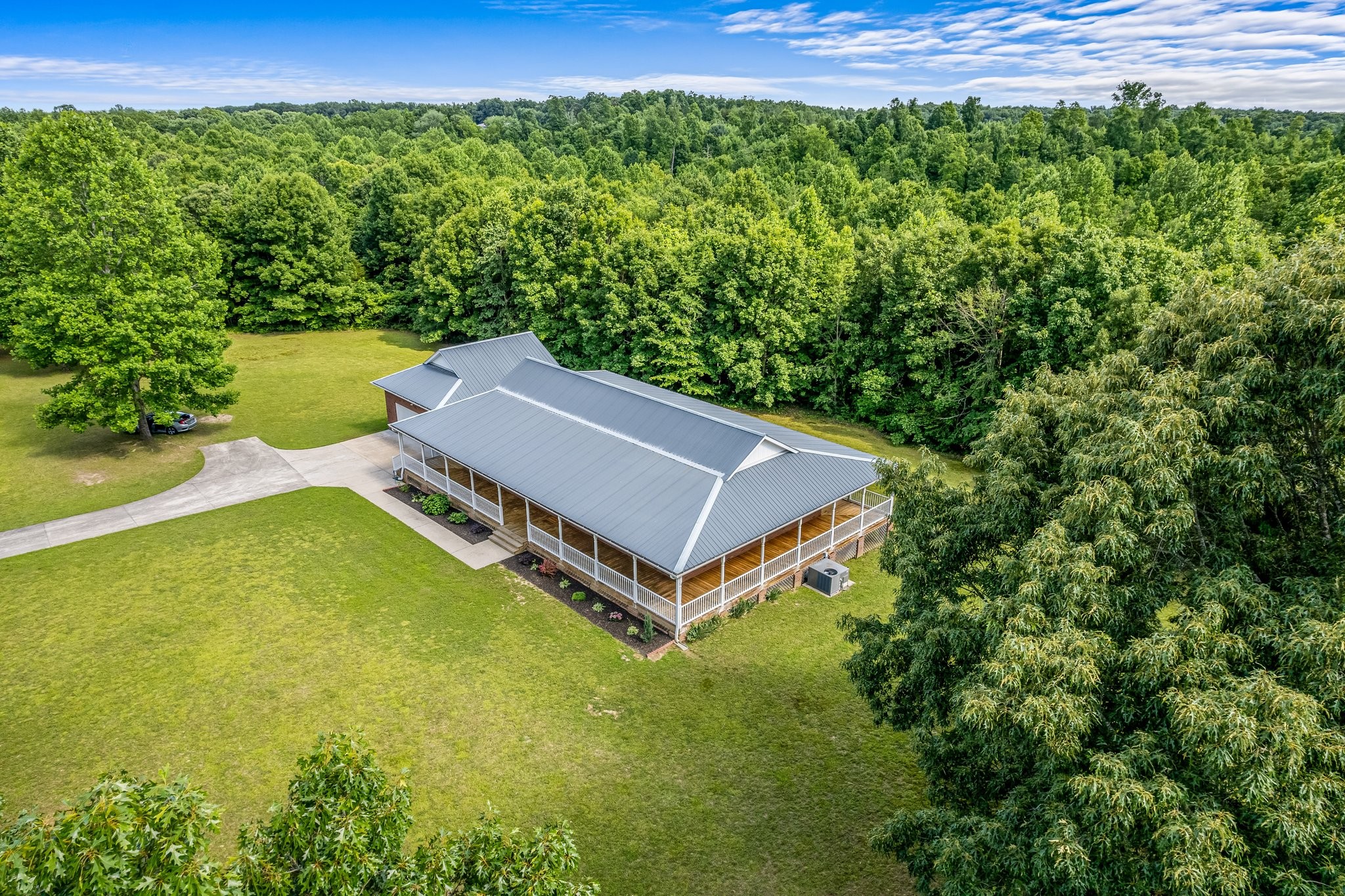10985 Missionary Ridge Road Bon Aqua, TN 37025 - Photo 3 of 43 a view of a backyard with plants and a garden