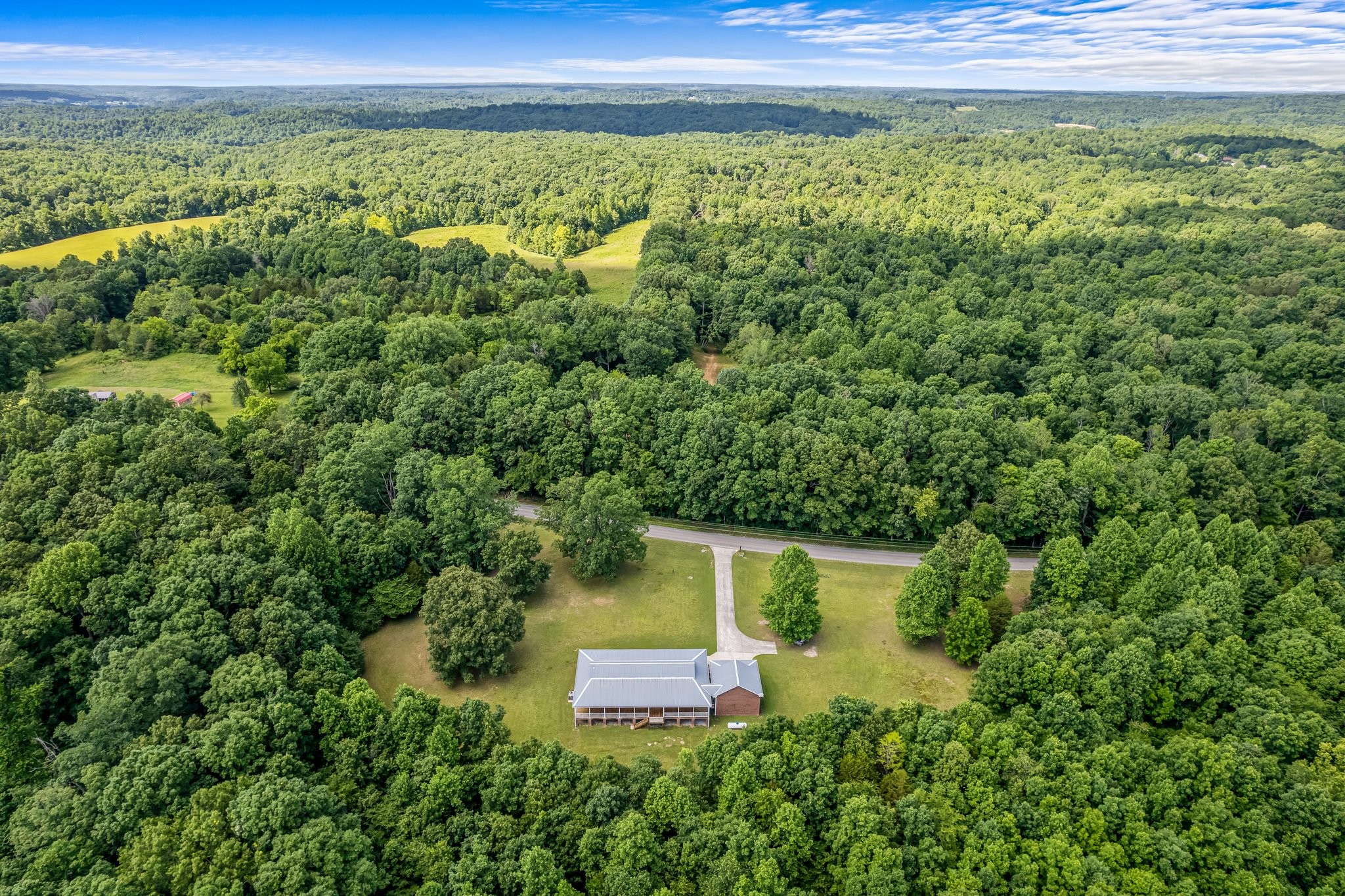 10985 Missionary Ridge Road Bon Aqua, TN 37025 - Photo 8 of 43 a view of a garden with a building in the background