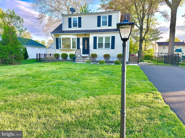a view of a brick house with a yard and plants