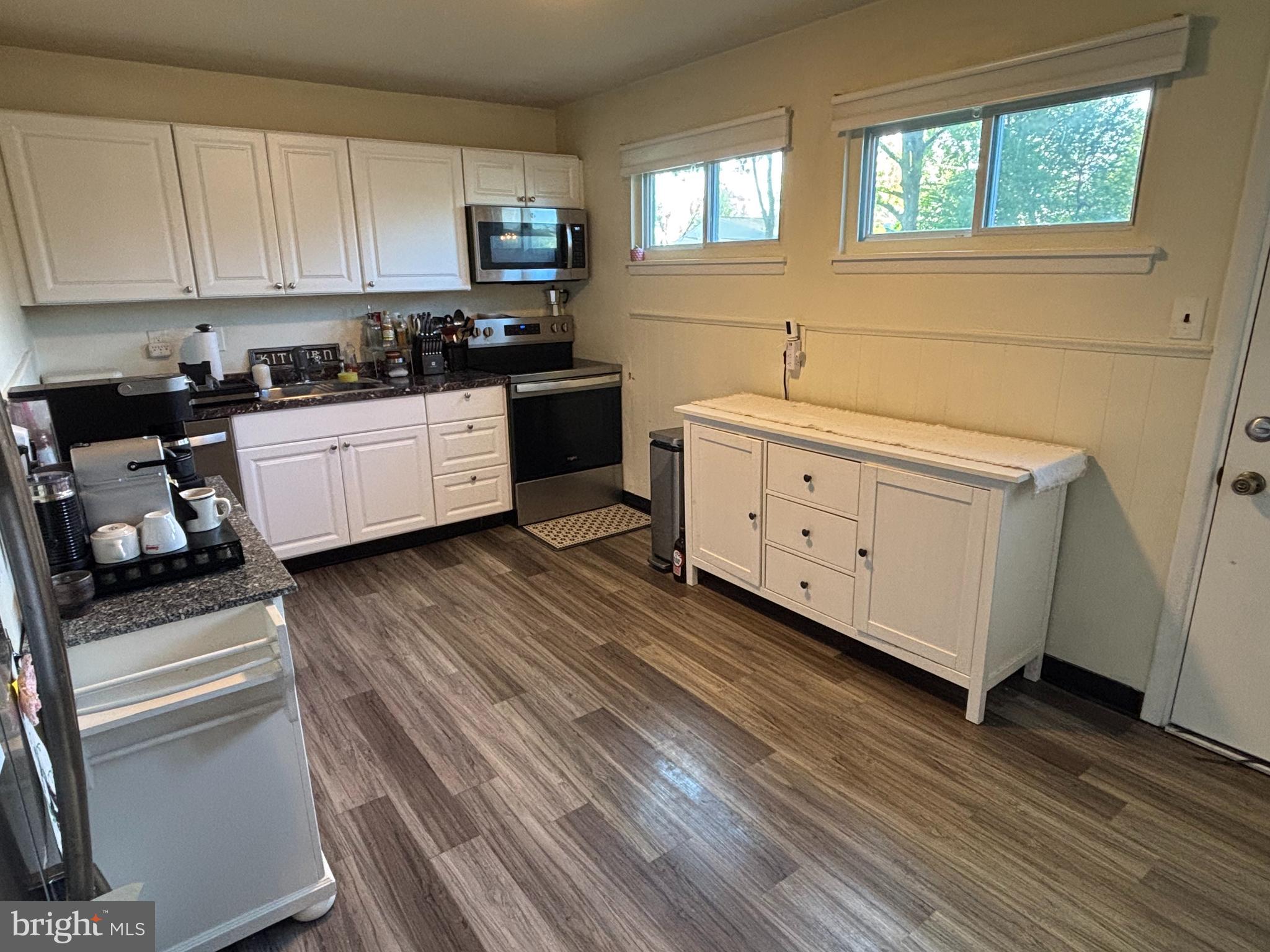 520 Olive Street Warminster, PA 18974 - Photo 6 of 8 a kitchen with granite countertop white cabinets and white appliances
