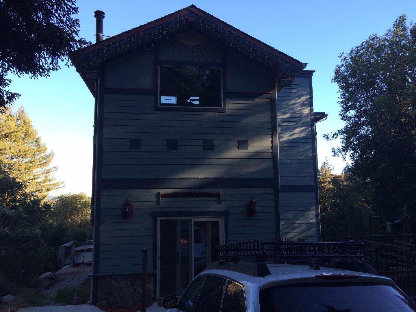 a front view of a house with plants