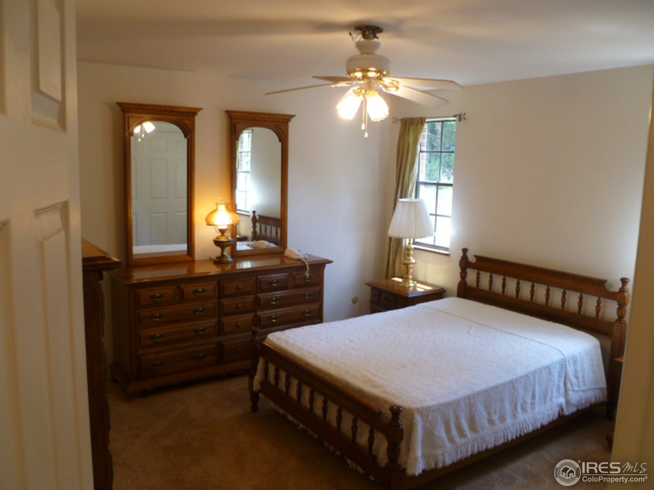 6940 Olde Stage Road Boulder, CO 80302 - Photo 12 of 14 a bedroom with a bed and a chandelier