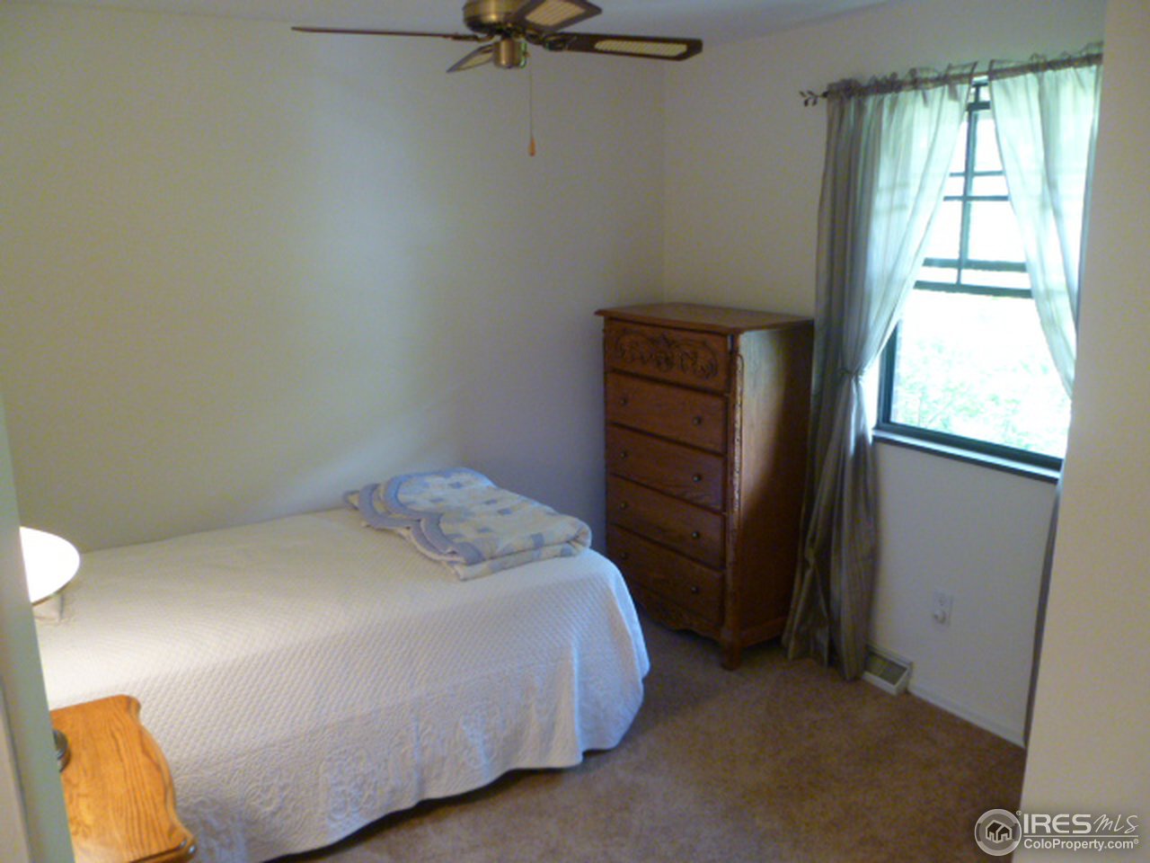 6940 Olde Stage Road Boulder, CO 80302 - Photo 14 of 14 a bedroom with a bed and a window