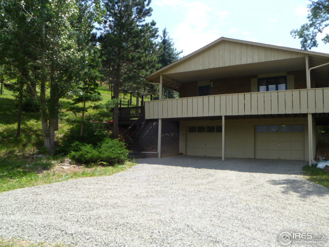 6940 Olde Stage Road Boulder, CO 80302 - Photo 4 of 14 a front view of a house with a yard and garage