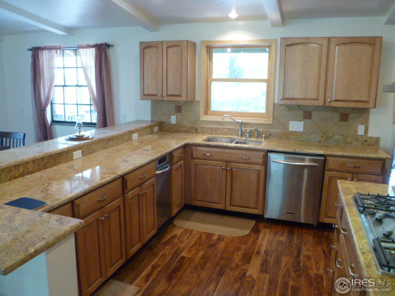 6940 Olde Stage Road Boulder, CO 80302 - Photo 8 of 14 a kitchen with a sink stove and cabinets