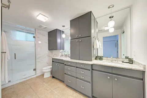 a large kitchen with kitchen island a sink stainless steel appliances and cabinets
