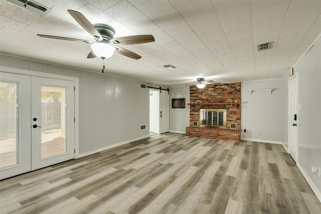 400 South Bailey Street Electra, TX 76360 - Photo 14 of 36 a view of empty room with wooden floor and fan