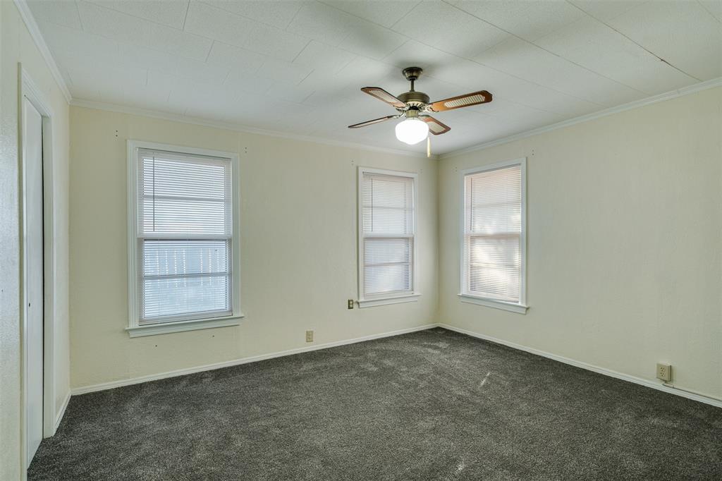 400 South Bailey Street Electra, TX 76360 - Photo 22 of 36 an empty room with windows and fan