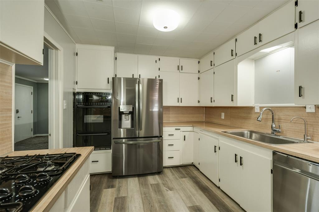 400 South Bailey Street Electra, TX 76360 - Photo 10 of 36 a kitchen with granite countertop a refrigerator stove and sink