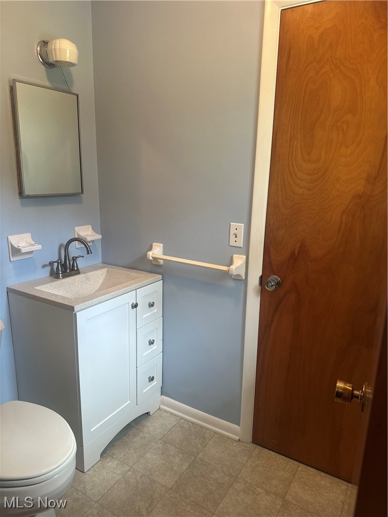 379 Wilson Mills Road Chardon, OH 44024 - Photo 16 of 20 Half bath featuring vanity, toilet, and baseboards