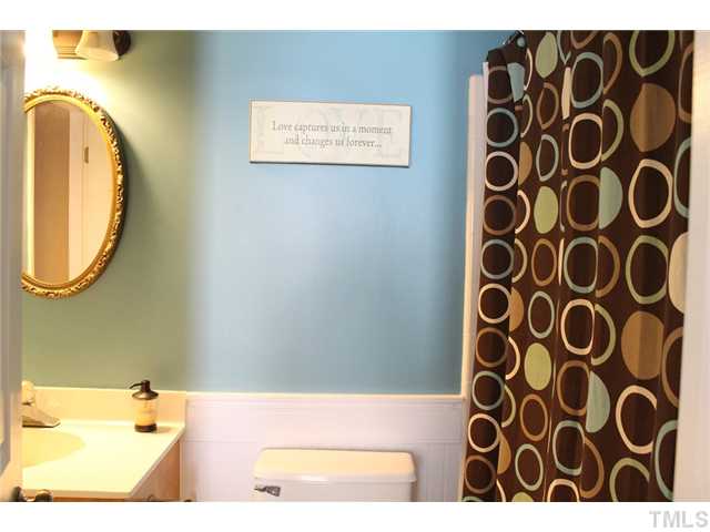 6924 Saxby Court Raleigh, NC 27613 - Photo 12 of 19 a picture of a bathroom with a sink and a mirror