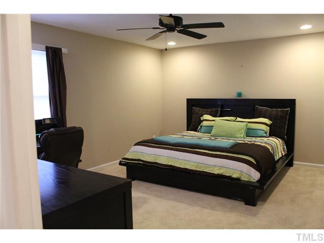 6924 Saxby Court Raleigh, NC 27613 - Photo 16 of 19 a bedroom with a bed and a potted plant