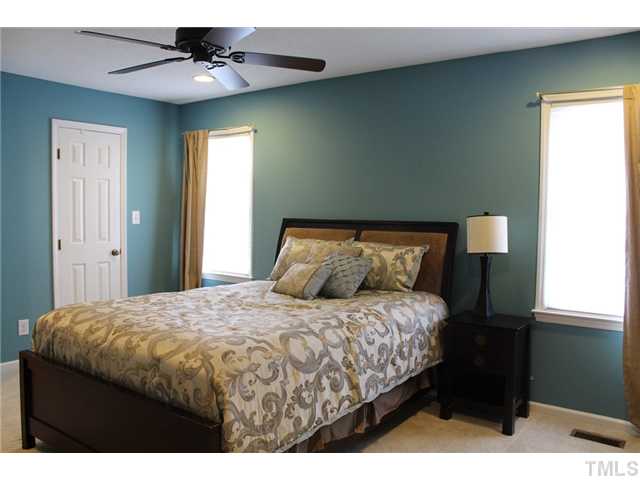 6924 Saxby Court Raleigh, NC 27613 - Photo 17 of 19 a bedroom with a bed and a ceiling fan