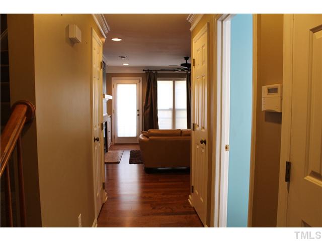 6924 Saxby Court Raleigh, NC 27613 - Photo 3 of 19 a hallway with couches and wooden floor