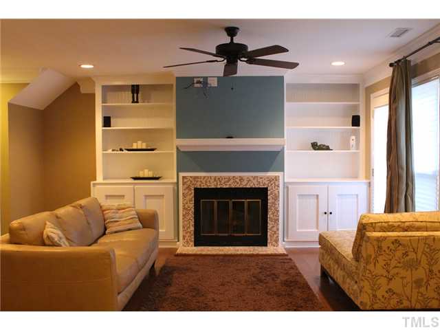6924 Saxby Court Raleigh, NC 27613 - Photo 6 of 19 a living room with furniture and a fireplace