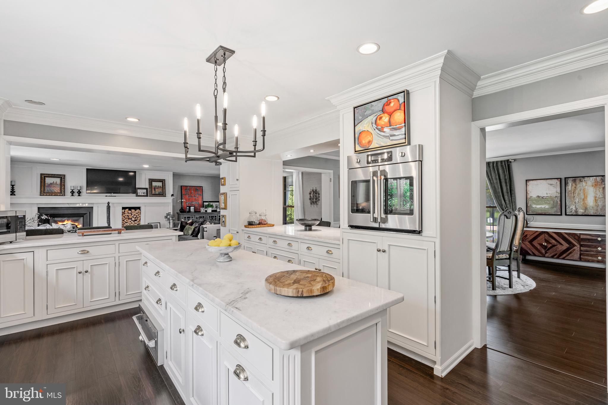 1179 Lafayette Road Wayne, PA 19087 - Photo 16 of 67 a kitchen with kitchen island granite countertop a sink cabinets and wooden floor