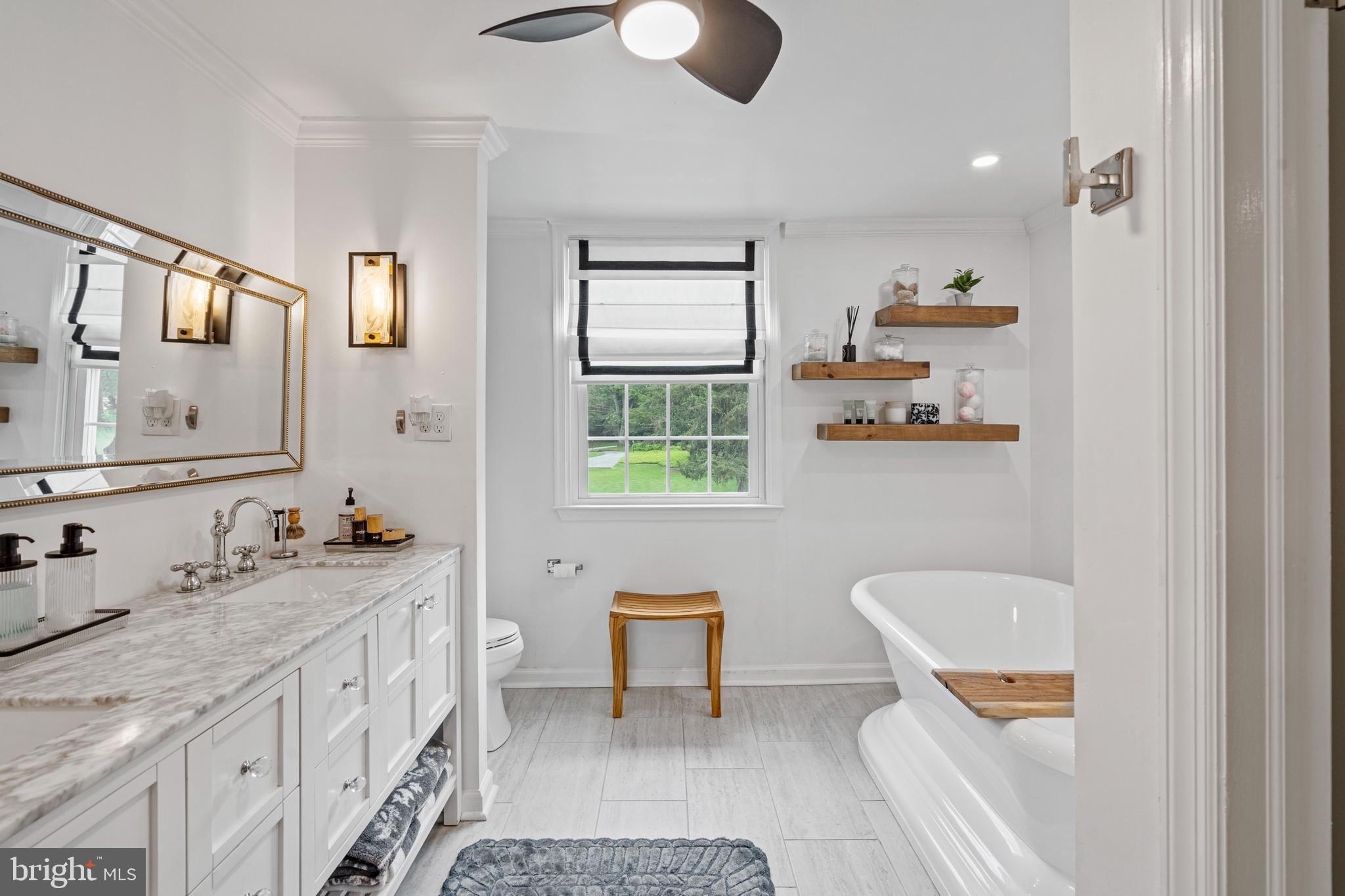 1179 Lafayette Road Wayne, PA 19087 - Photo 28 of 67 a bathroom with a granite countertop sink a toilet and a mirror