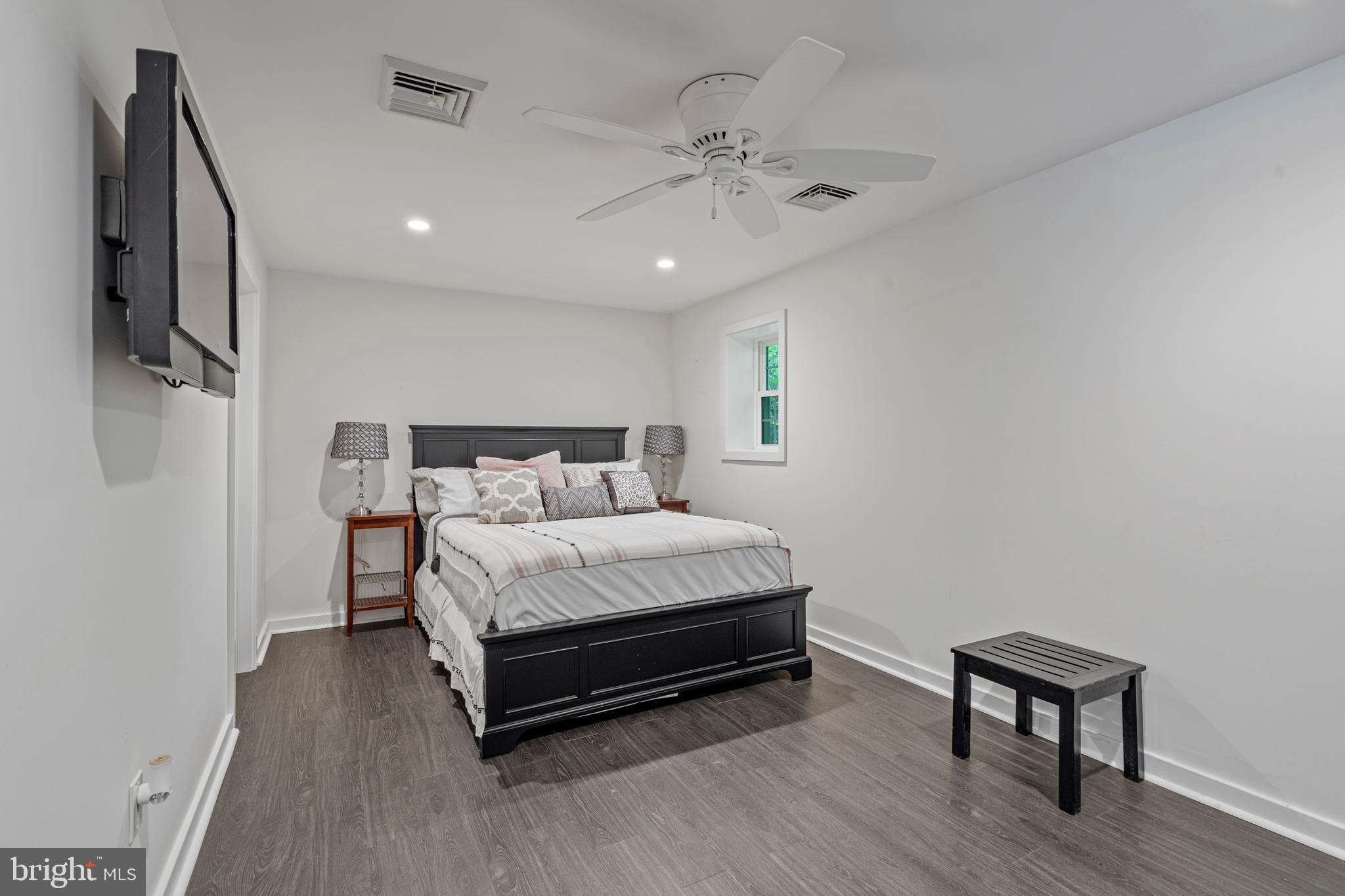 1179 Lafayette Road Wayne, PA 19087 - Photo 48 of 67 a spacious bedroom with a bed and a chandelier