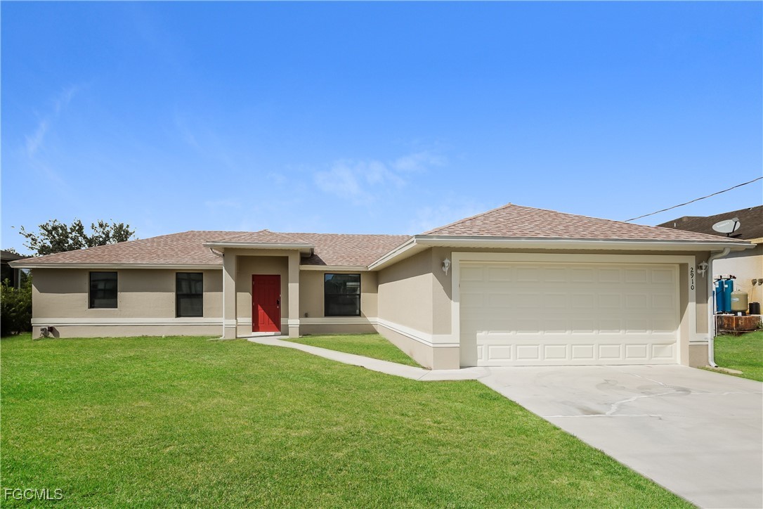 a front view of a house with a yard and garage