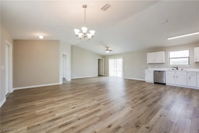 a view of a room with wooden floors and white walls