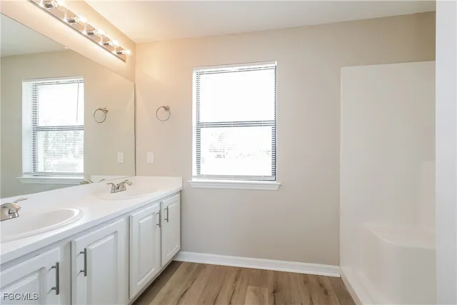 a bathroom with a sink a mirror and a window