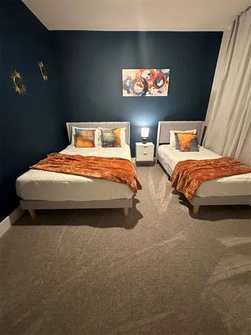 a bedroom with bed and glass window