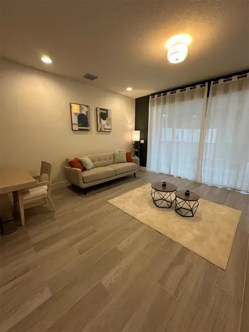 a bedroom with furniture and a wooden floor
