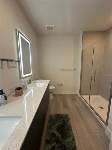 a bathroom with a tub sink and mirror