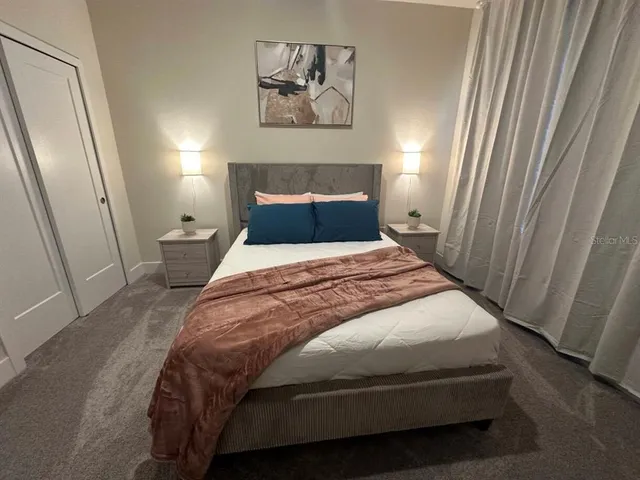 a bedroom with a bed and a window