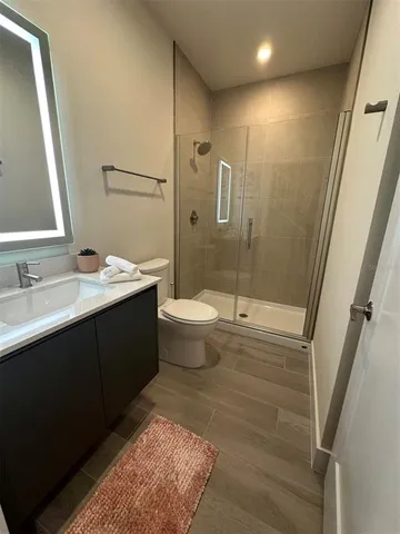 a bathroom with a double vanity sink toilet and shower