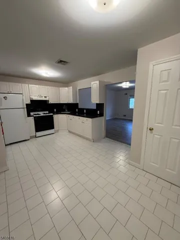 an empty room with kitchen