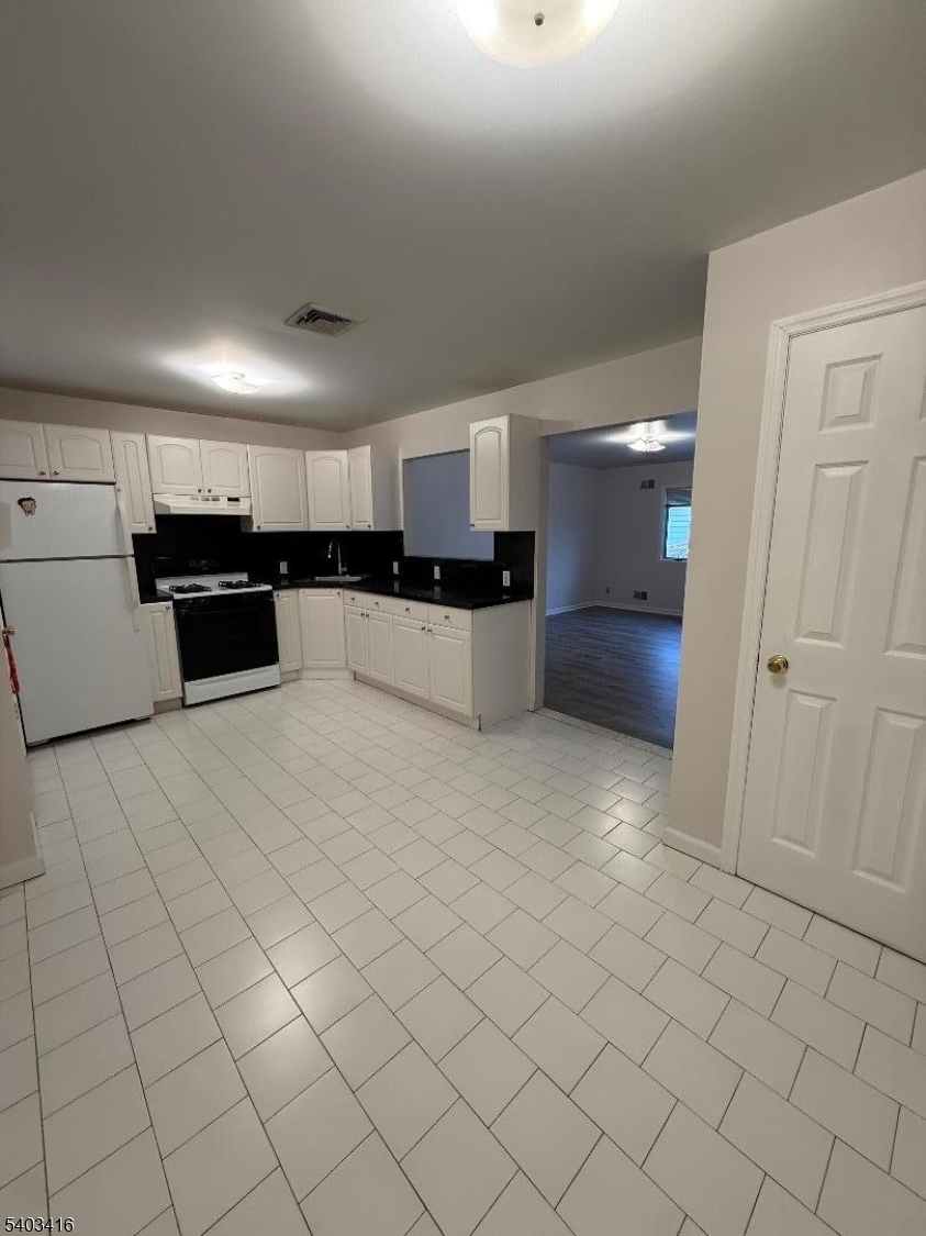 360 Ridge Road Lyndhurst, NJ 07071 - Photo 2 of 9 an empty room with kitchen