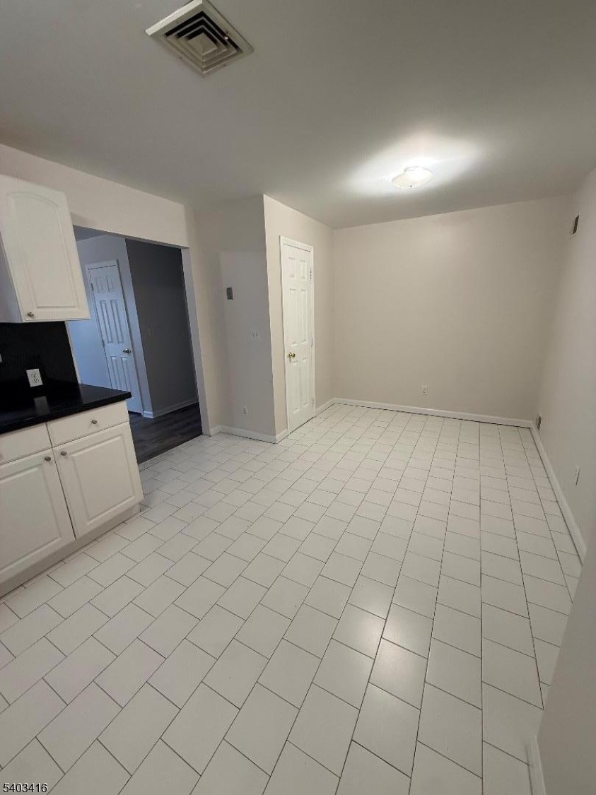 360 Ridge Road Lyndhurst, NJ 07071 - Photo 3 of 9 an empty room with white walls and tiles