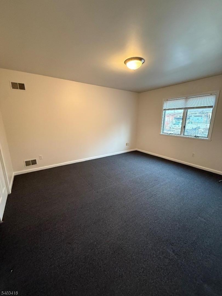 360 Ridge Road Lyndhurst, NJ 07071 - Photo 4 of 9 a view of an empty room with a window