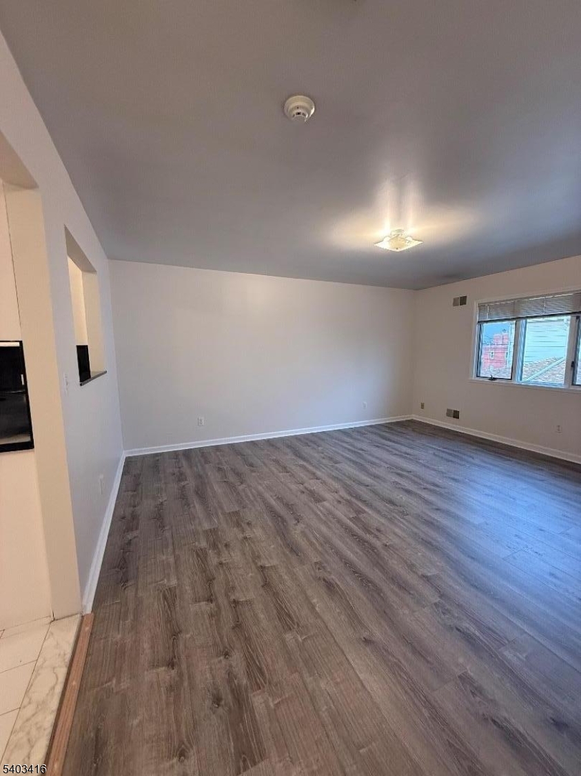 360 Ridge Road Lyndhurst, NJ 07071 - Photo 8 of 9 an empty room with wooden floor and door